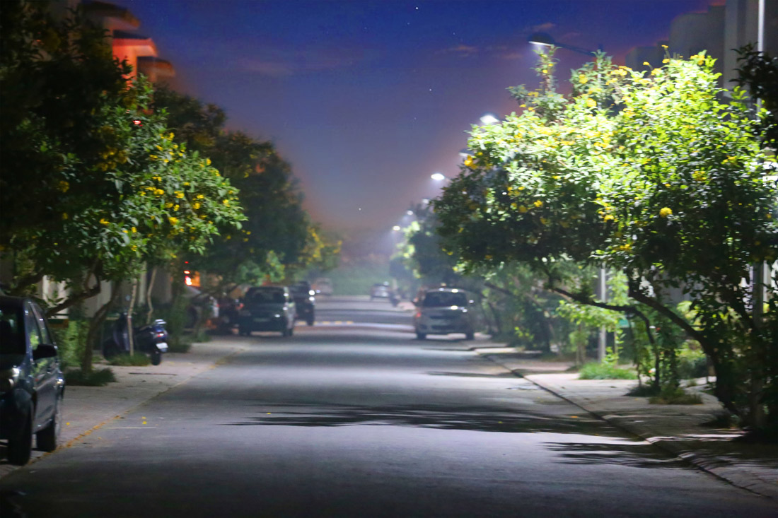 Night view of Paramount Golf Foreste Clubhouse and lit-up pathways